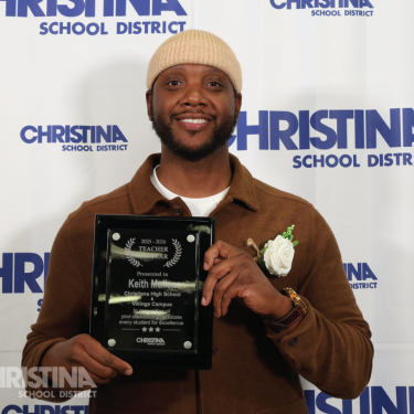 Photo of Keith Mullen Christiana Vikings Campus 2025-2026 Teacher of the Year holding plaque